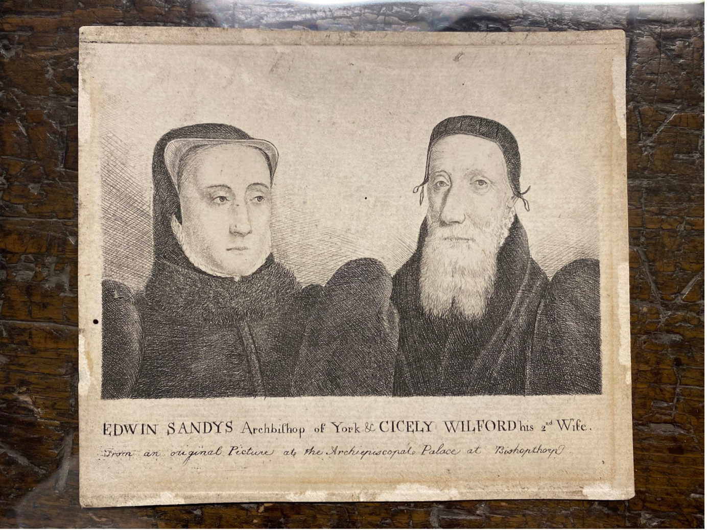 Engraving of Cicely Wilford and her husband Edwyn Sandys. Black and white portraits. The person on the left is wearing a hood and the person on the right has a white beard and is wearing a bonnet.